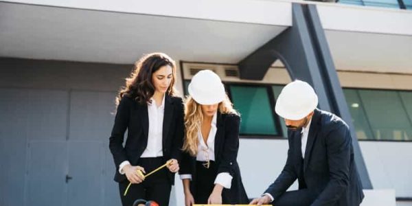 three-architects-wearing-helmets